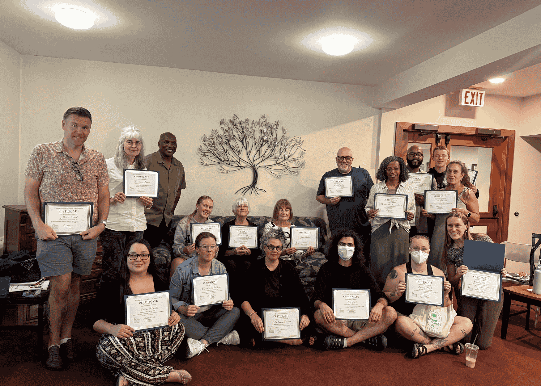 RJ training participants gathered for a photo holding their certificates.